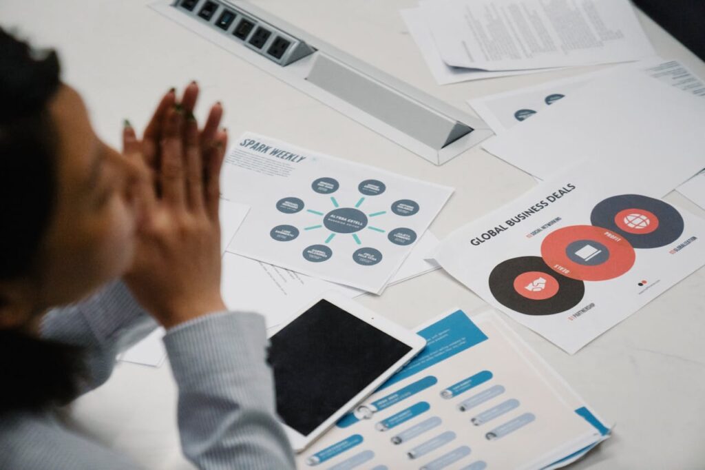 Businesswoman reviewing charts and documents during a professional meeting in an office setting.